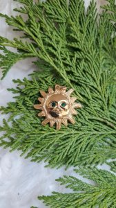 Pendentif Soleil Dalloyau année 1993 yeux vert