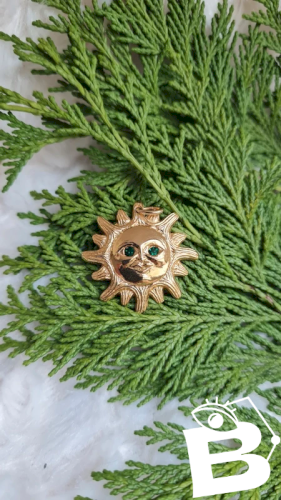 Pendentif Soleil Dalloyau année 1993 yeux vert
