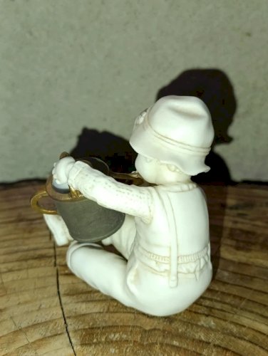 petite sculpture ancienne en porcelaine enfant à larrosoir en bon etat