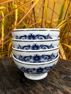 Small Limoges porcelain bowls with blue flower designs.