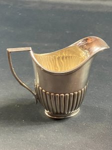 English silver-plated milk jug with fluted decoration