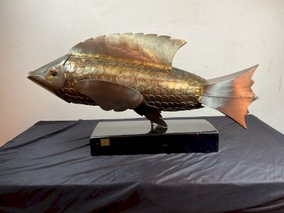 abstract steel fish sculpture on modern contemporary reed.