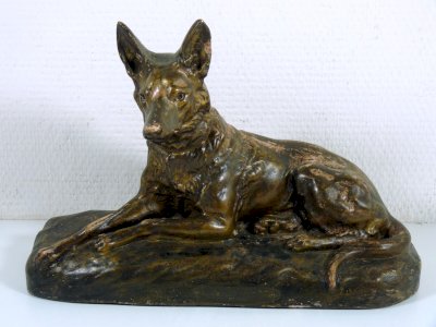 Polished terracotta sculpture of a police dog on a pedestal signed Emile Rouff.