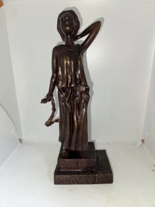 bronze sculpture of a woman with chains in good condition