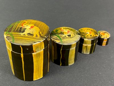 Set of 4 nesting boxes made of painted wood decorated with elephants.
