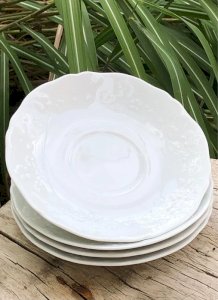 White porcelain saucers from Limoges with raised flower patterns