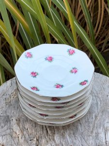 Retro vintage porcelain saucers with small pink flower patterns.