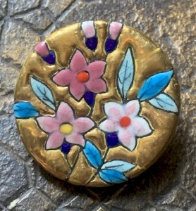 Beautiful enamel brooch from Longwy with floral design on a gold background.