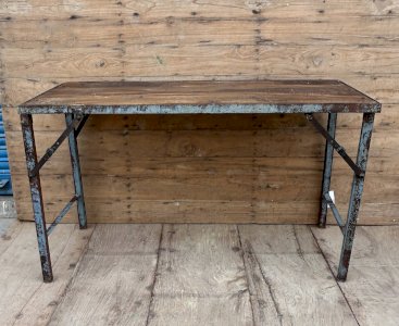 Folding workshop table with a metal frame and a solid teak top.