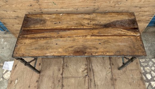 Folding workshop table with metal structure and solid teak top.