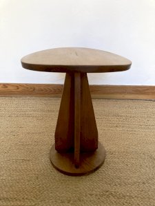 Wooden stool with a convex seat