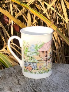 Porcelain cup made in Romania with a countryside design.