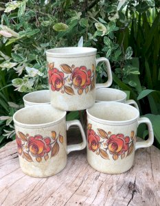 Vintage stoneware mugs with orange flower patterns