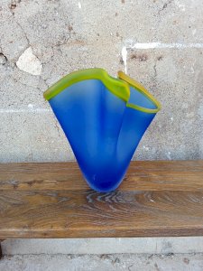 Frosted blue glass tissue holder, delicately accented with a yellow rim.